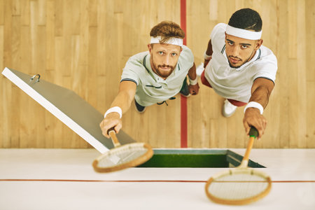 Portrait, above and men with racket, squash court and fitness with competition, workout and hobby. Face, top view and players with match, recreation and activity with confidence, training and sportsの写真素材