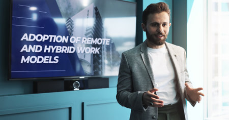 Businessman, meeting and presentation with screen for new strategy, discussion or innovation at office. Man, speaker or employee with technology display or proposal for remote or hybrid developmentの写真素材