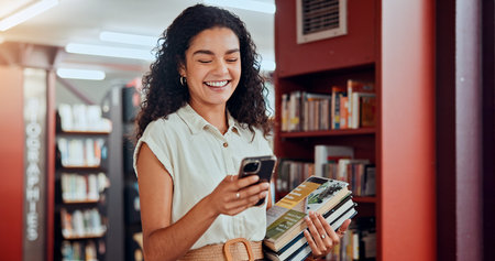 Woman, phone and books with texting at library with smile, contact and excited with studying at...