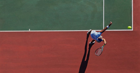 Tennis, serve and man on outdoor court with challenge, performance and action game from above. Racket, ball and professional athlete at lines for fitness, wellness and competition at sports clubの写真素材