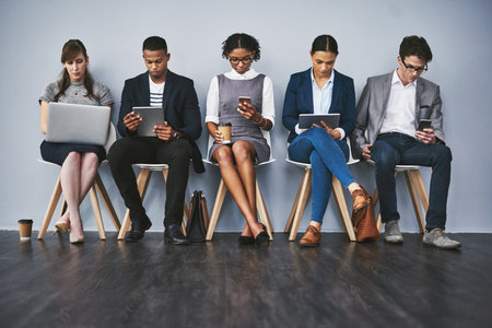 Technology, search or business people waiting for hiring app, recruitment or job interview in office. Sign up, phone or candidates on tablet in corporate for employment opportunity or registrationの写真素材