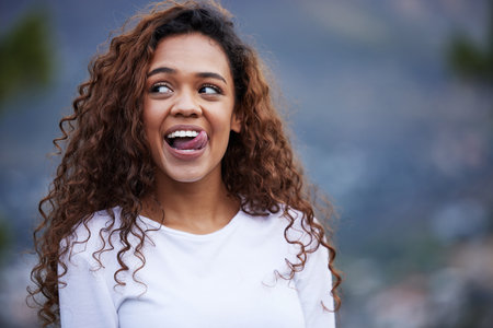 Running, fitness and woman with funny face in nature for training, exercise or morning cardio break. Silly, moody and gen z runner outdoor with comic expression, fun or quirky personality for workoutの写真素材