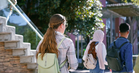 Back of girl, morning or college student walking to class for learning, future or study in...