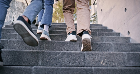 Feet, students and walking on steps at school for education, learning break and studying of classroom lesson. People, legs and stairs for knowledge, university and travel for morning path outdoorの写真素材