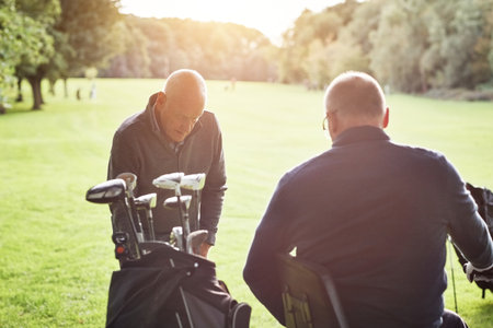 Men, golf course and club bag for sport practice together or recreation hobby or professional, competition or summer. Male people, friends and equipment for grass training or playing, activity or kitの写真素材