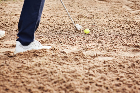 Golf, sand and closeup bunker for playing with ball and metal club on outdoor pitch or field. Sports, ground and zoom of person hitting equipment on course for match, training or game practice.の写真素材