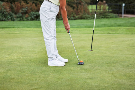 Legs, sports and person with club on golf course, ready for swing and exercise outdoor for...