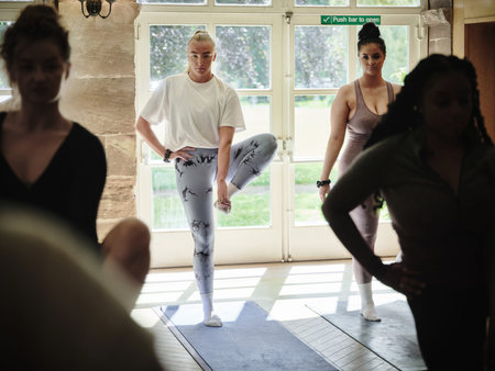 Friends, stretching and women with balance, fitness and workout with wellness, muscle warm up and...