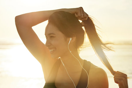 Fitness, beach and thinking with woman prepare for running, workout and sunset with music. Athlete,...