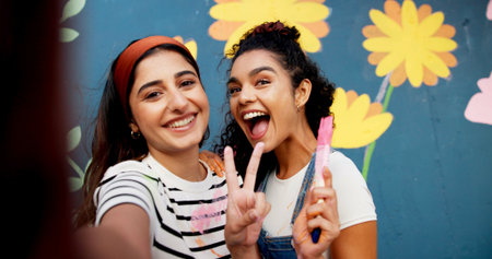 Selfie, painting and wall with friends and peace sign for flower mural, earth day promotion or...