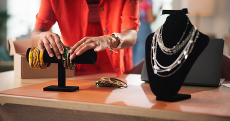 Startup, jewelry and hands of woman in office for small business, designer and retail supplier. Display, fashion and person with accessories for inventory, creative industry and stylist for boutiqueの写真素材