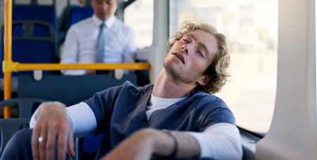 Nurse, public transportation and sleeping with man on bus for commute or travel to healthcare job. Burnout, fatigue and scrubs with tired medical professional in hospital vehicle for journey to workの写真素材