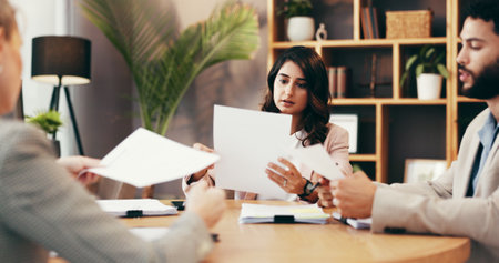 People, lawyers and reading documents in office for legal report, information and negotiation. Staff, attorney and paperwork with case settlement, contract update and procedure for policy managementの写真素材