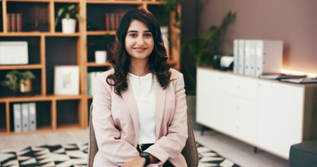 Portrait, office and happy business woman with pride, ambition and attorney at corporate law firm. Smile, confidence and professional employee at work, lawyer and legal representative in Portugalの写真素材