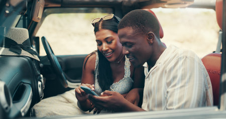 Couple, phone and road trip in car, happy and check direction for location, journey and vacation. People, man and woman on smartphone, smile and mobile app with map for travel with vehicle on holidayの写真素材