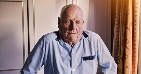 Senior man, thinking or sad in bedroom with anxiety, grief or frustrated alone in retirement in...