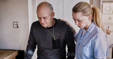 Medical, help and nurse with senior man in a nursing home kitchen with crutches and consultation. Healthcare, career and female caregiver with elderly male patient in retirement at modern house.の写真素材