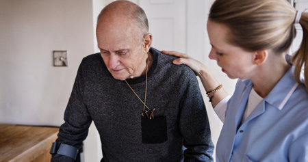 Medical, help and nurse with elderly man in a nursing home kitchen with crutches and consultation. Healthcare, career and female caregiver with senior male patient in retirement at modern house.の写真素材