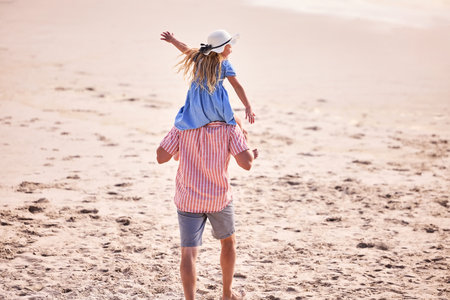 Father, daughter and plane on shoulders at beach with care, bonding and love for walk on vacation. Man, dad and girl with airplane, flight and piggy back for games, connection and playful in sunshineの写真素材