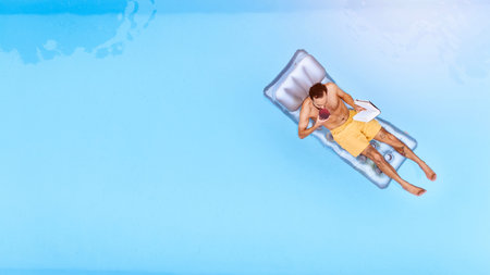 Relax, drink and man on inflatable in swimming pool for summer vacation, weekend break or getaway at...
