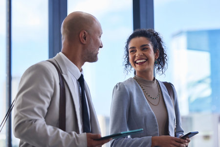 Collaboration, technology and walking with business people in office for administration or conversation. Accounting, audit and management with man talking to woman employee in corporate workplaceの写真素材