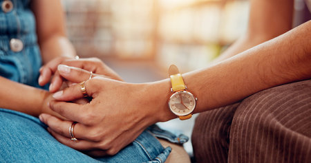 Holding hands, woman and girl with care, comfort and compassion with trauma counselling. Closeup,...