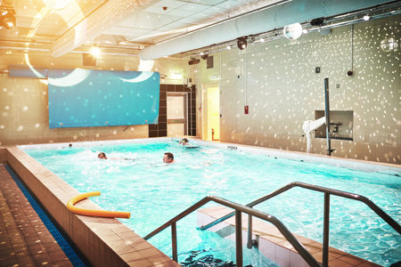 Luxury people in spa indoor swimming pool in hotel on vacation, travel or holiday in water for the...