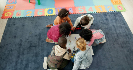 Above, education and drawing with kids in classroom for child development, artwork and creative project. Youth, academy and growth with students at school for knowledge, learning and kindergartenの写真素材