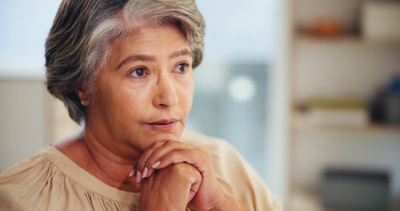 Thinking, senior woman and relax at house for reflection, loneliness and nostalgia for past memory. Elderly person, thoughts and remember for partner loss, waiting and mourning with dementia historyの写真素材
