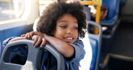 Thinking, bus or travel with boy, kid and smile for commute with urban journey, scholarship and school trip. Academy, passenger or child in city with imagination, public transport or adventure ideasの写真素材