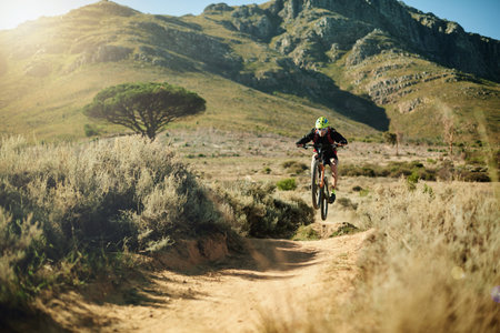 Mountain, cycling and man with bicycle, fitness and speed for race in nature, carbon footprint and...