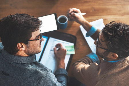 Designer, writing or people in startup for team planning, company growth strategy or collaboration. Brainstorming, paperwork or above of creative workers in meeting for project development discussionの写真素材