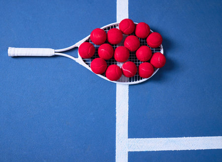 Red balls, tennis court and fitness with racket for sport, training and exercise for competition or tournament. Above, workout and practice for talent or hobby with kit for athletics games for playの写真素材