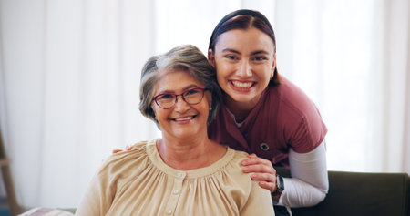 Home, portrait and nurse with old woman, smile and support with trust in living room. Face, pensioner and caregiver in lounge, happiness and confidence with healthcare, service and retirementの写真素材