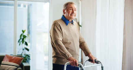 Walking frame, thinking and senior man in home for help, support and mobility assistance. Retirement, health and elderly person with disability with cane for wellness, injury recovery and balanceの写真素材