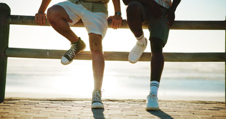 Men, legs and friends at beach for break with bonding, fashion shoes and support outdoor. Style,...
