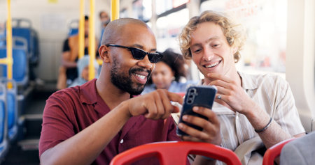 Smile, men and friends with phone on bus for browsing social media, reading blog and public transport. Happy, people and point with mobile for commute schedule, chat notification and morning journeyの写真素材