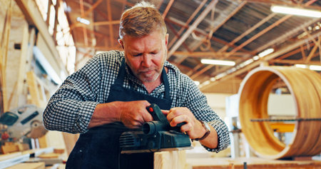 Carpentry, industry or sander with man in workshop for manufacture or production process. Design,...