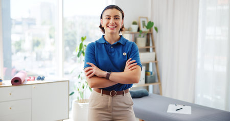 Crossed arms, physiotherapy and portrait of woman in office for wellness, physical therapy and medical service. Healthcare, professional and happy person for rehabilitation, mobility and recoveryの写真素材