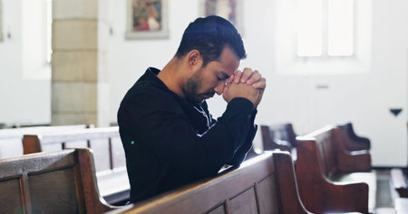Church, sad man and prayer for faith with religion, respect and worship God at funeral service....
