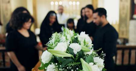 Funeral, respect or family with flowers in church for farewell service, mourning death or grief....