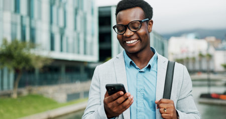 Happy, phone and African businessman in city online for morning commute, travel and journey to...