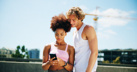 Woman, man and phone for fitness, city and happy with search for direction, location and training on bridge. Interracial couple, runner and smartphone on timer app, workout and check stats in streetの写真素材