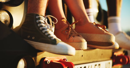 Travel, feet and friends on vacation, road trip and bonding on journey with car, resting and group. Outdoor, shoes and people on vehicle for break, getaway and summer holiday for reunion or studentsの写真素材