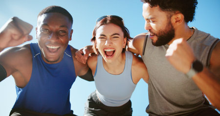 Happy people, fitness and hug with fist pump for winning, success or health and wellness together. Active, group or excited friends with smile for workout, teamwork or exercise achievement in natureの写真素材
