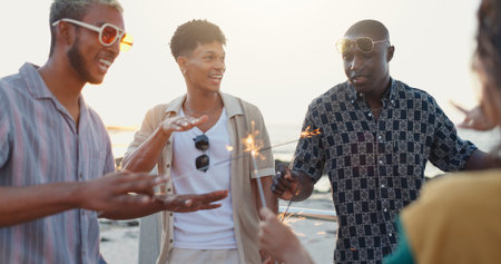 Beach, friends and dance with sparklers for holiday, social gathering and new year party....
