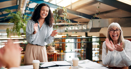 Clapping, business women and celebration for success, results and accomplishment in office. Excited group, applause and cheers for good news, promotion and achievement recognition for winning rewardの写真素材