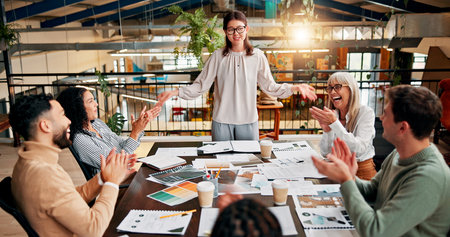 Creative paperwork, team and applause in meeting for campaign performance, good news and project success. Design agency, above and people with clapping hands for marketing pitch approval and feedbackの写真素材