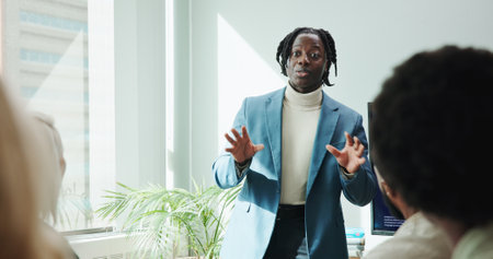 Man, speech and meeting for workshop with office, support and employee engagement. Male person, seminar and presentation with speaker, training and briefing for advice, learning and brainstormingの写真素材