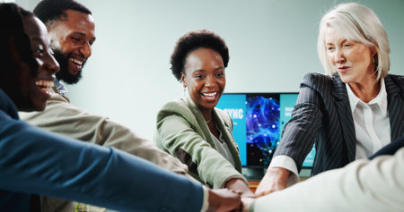 Business people, hands together and fist bump for meeting with motivation, smile or employee engagement. Data analyst, huddle and proposal with celebration, project or advice for community discussionの写真素材